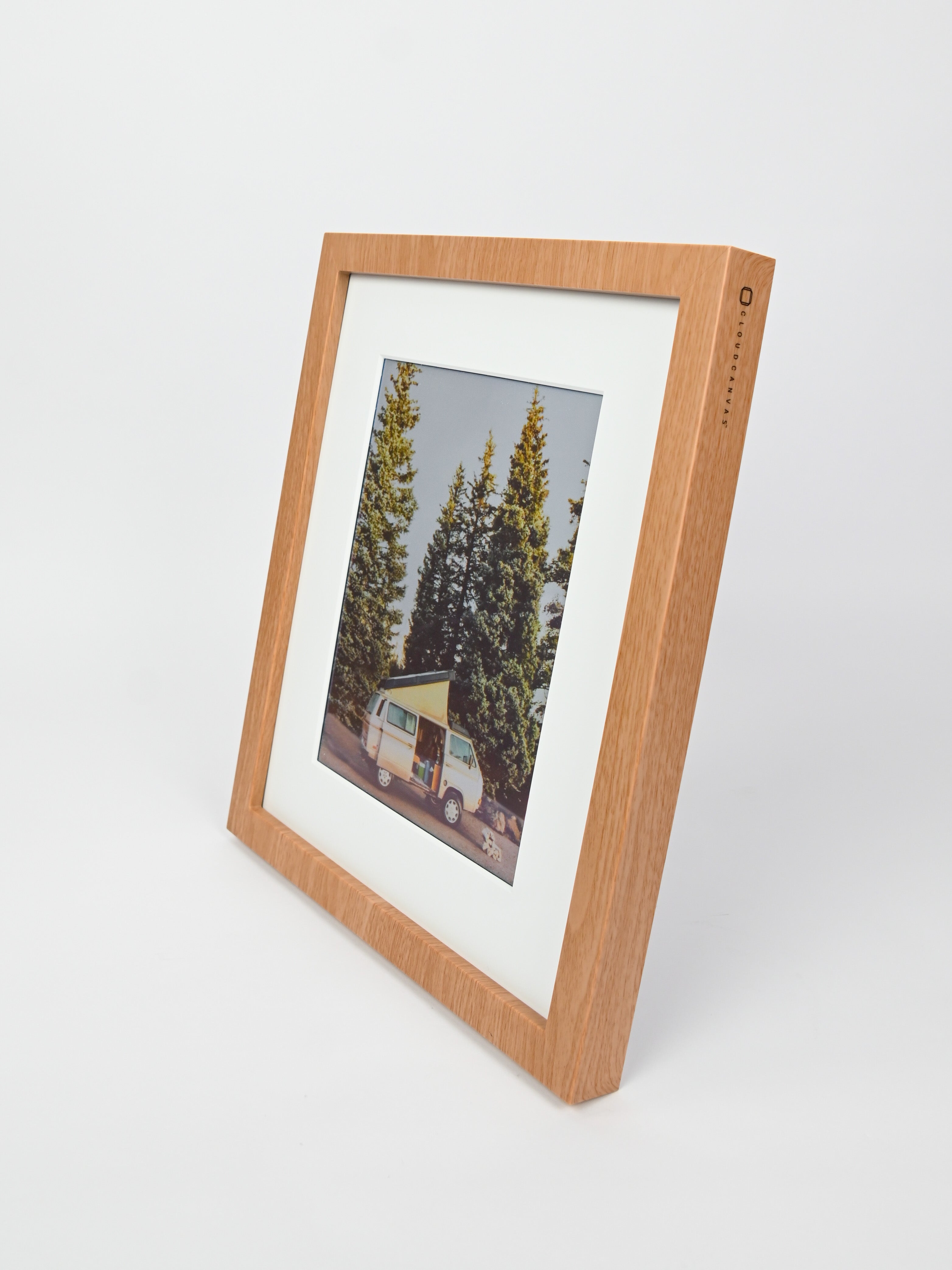 Wooden picture frame with a photo of a van and trees inside, on a white background #wood