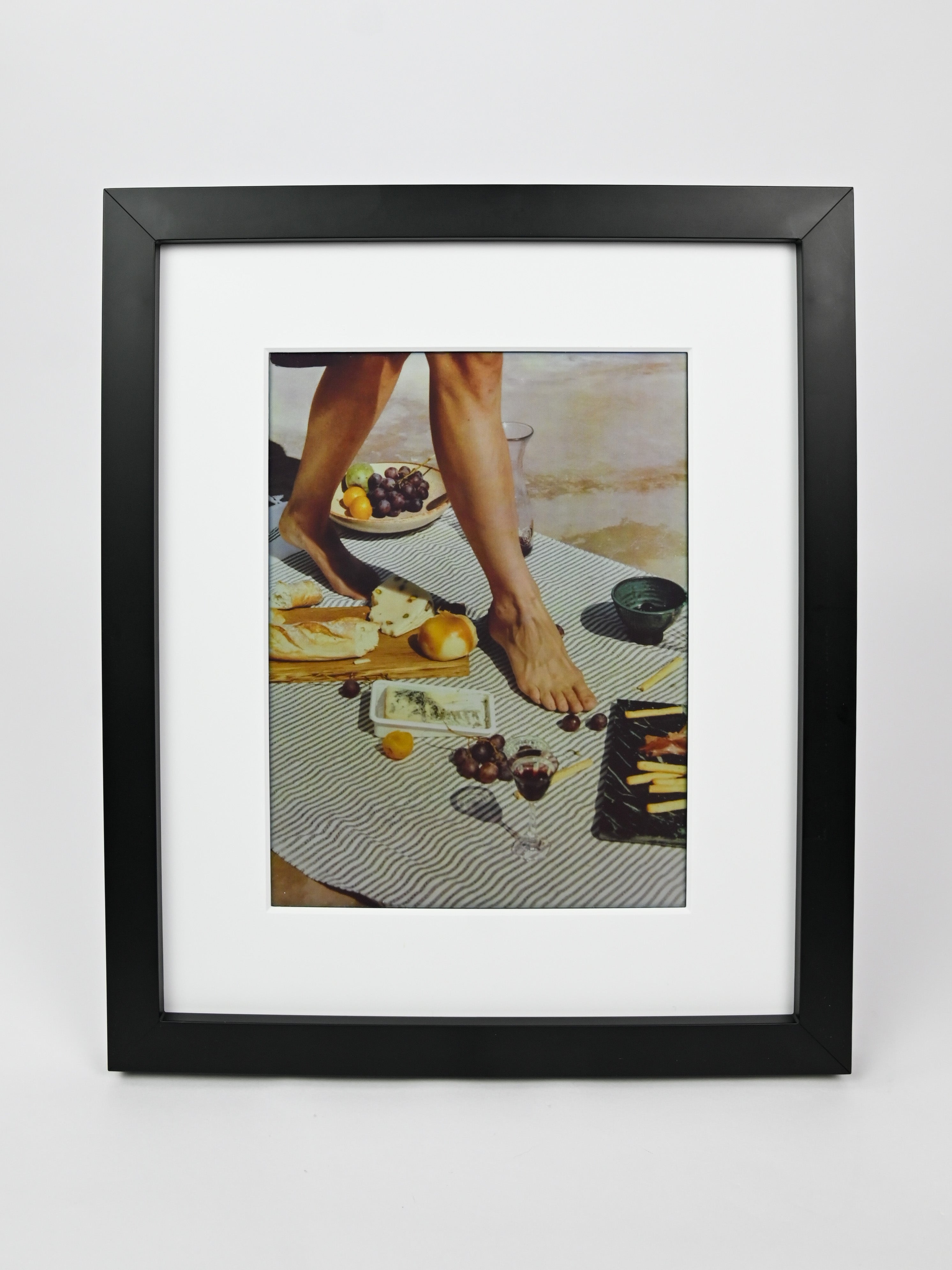 Black framed photo of a person at a table with food on a white background #black