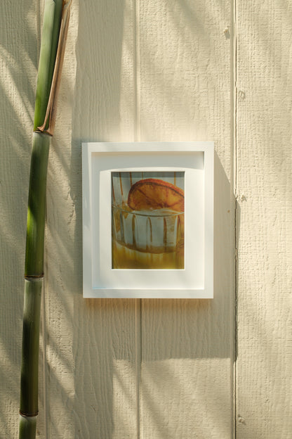 Framed artwork on a textured wall with a bamboo stick #white