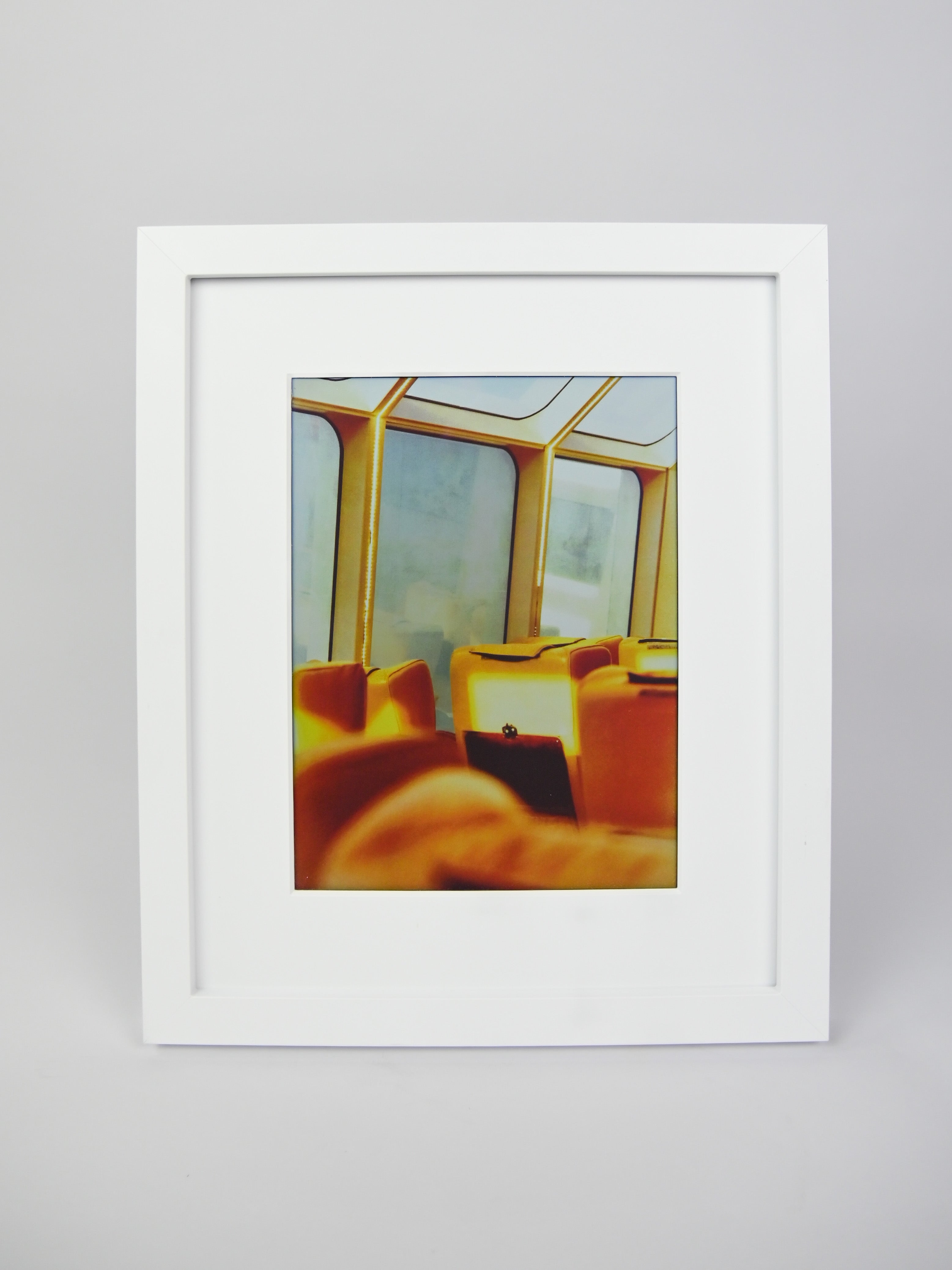Framed photograph of a room with yellow chairs and large windows on a gray background #white