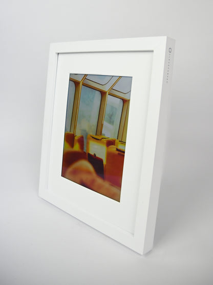White digital photo frame displaying a colorful image on a light gray background #white