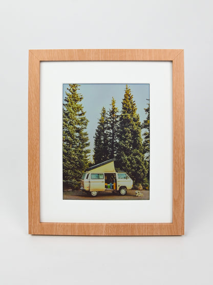 Framed photograph of a camper van in a forest with a wooden frame. #wood