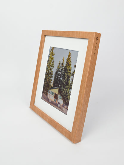 Wooden picture frame with a photo of a van and trees inside, on a white background #wood