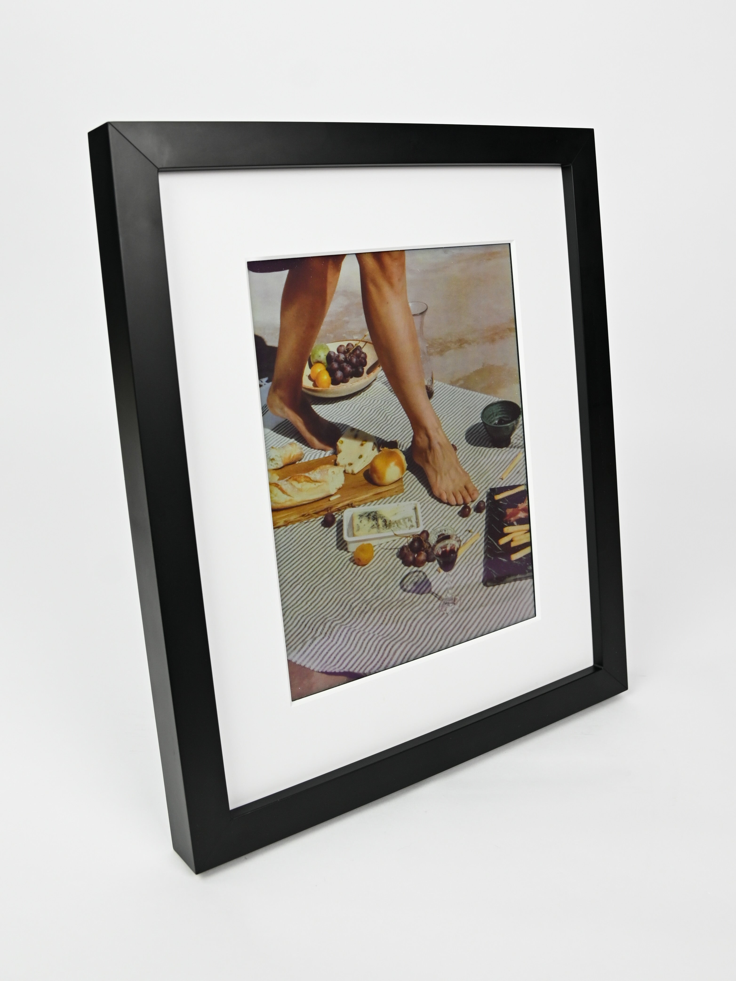Black framed photo of a person at a table with food on a white background #black