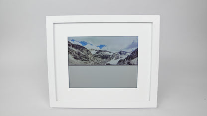 Framed photograph of a mountain landscape on a gray background #white